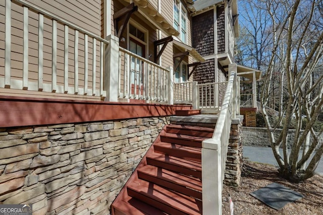 view of side of home featuring stairs