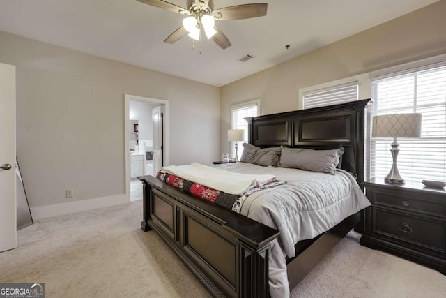 bedroom with light carpet, baseboards, visible vents, connected bathroom, and ceiling fan