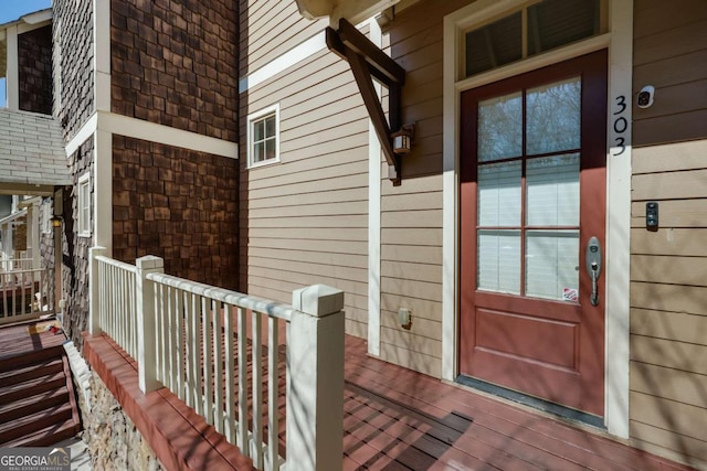 view of exterior entry featuring brick siding