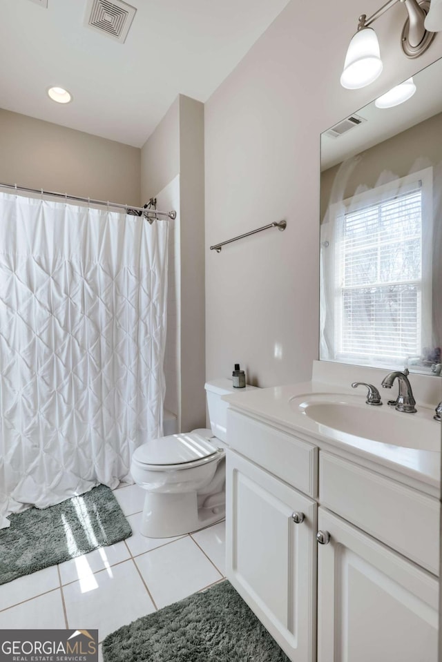 bathroom with toilet, tile patterned flooring, visible vents, and vanity