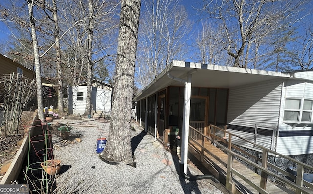 view of property exterior with an outbuilding