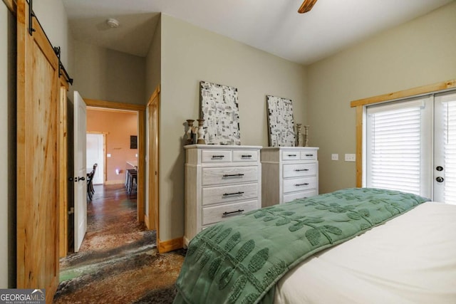 bedroom featuring a barn door, a ceiling fan, and baseboards