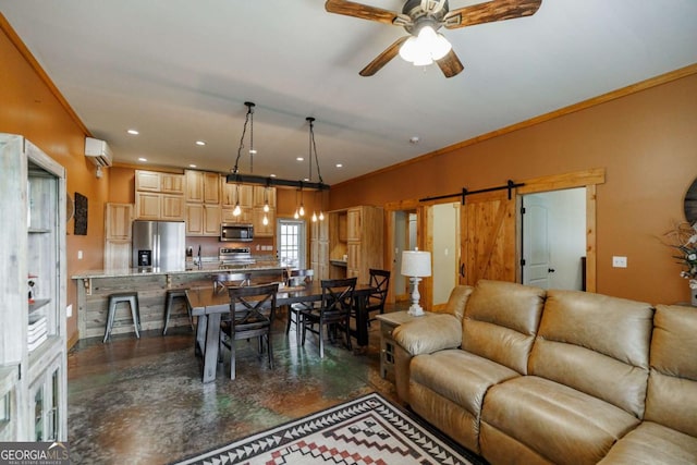 living area with a wall unit AC, crown molding, a barn door, a ceiling fan, and concrete floors