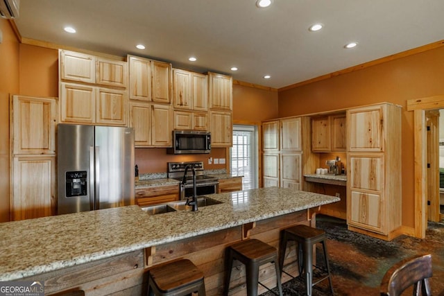 kitchen featuring light stone countertops, stainless steel appliances, a sink, and recessed lighting