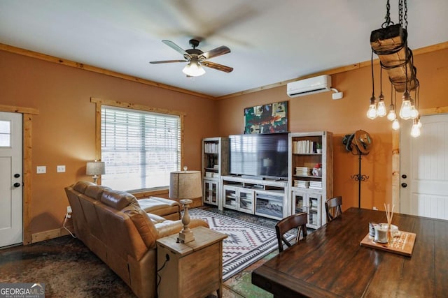 living area with ceiling fan, a wall mounted air conditioner, and baseboards