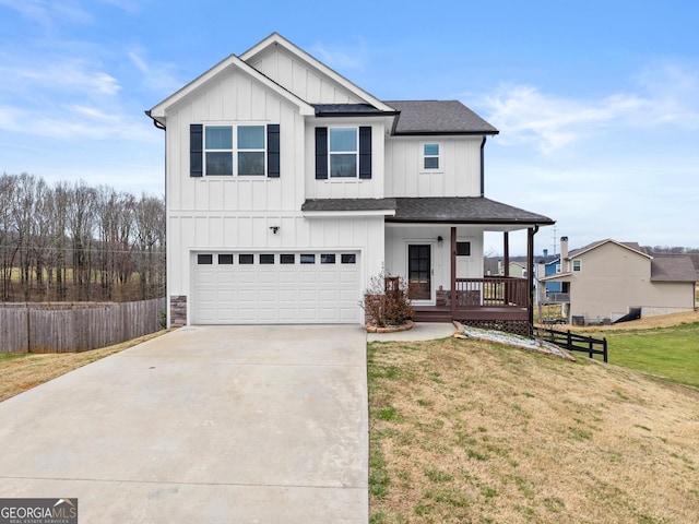 modern inspired farmhouse with an attached garage, covered porch, fence, a front lawn, and board and batten siding