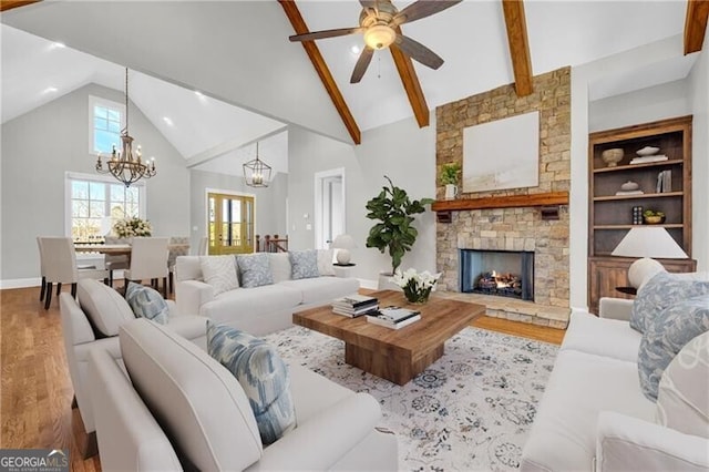 living room with a healthy amount of sunlight, a fireplace, and wood finished floors