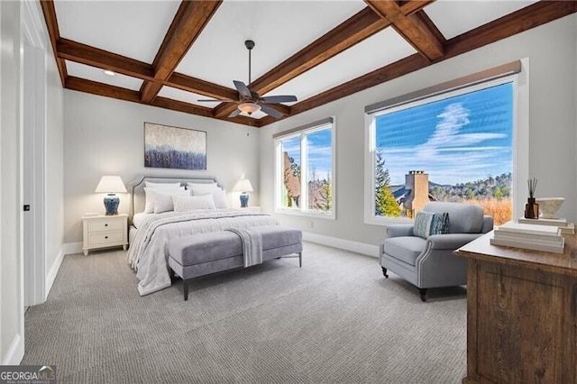 carpeted bedroom featuring beamed ceiling, coffered ceiling, a ceiling fan, and baseboards