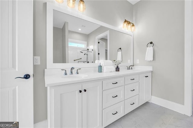 bathroom featuring double vanity, baseboards, a shower, marble finish floor, and a sink