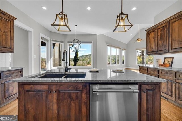 kitchen featuring a sink, light wood-type flooring, light stone counters, and dishwasher