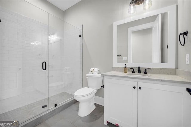 full bathroom with toilet, a shower stall, baseboards, and vanity