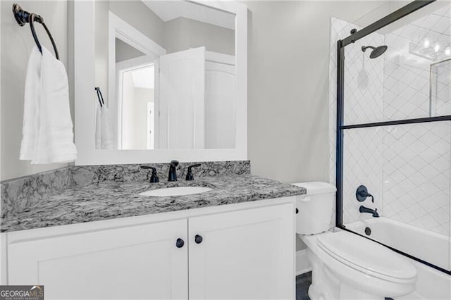 bathroom featuring shower / bath combination with glass door, vanity, and toilet