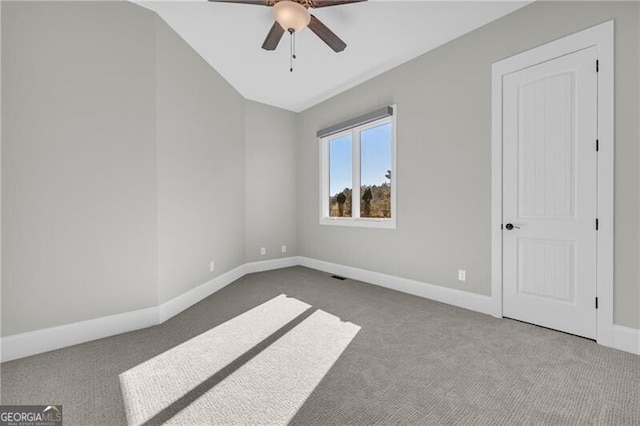 unfurnished room with carpet floors, ceiling fan, baseboards, and lofted ceiling