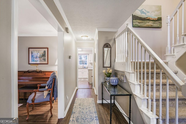 foyer with stairway, crown molding, baseboards, and wood finished floors