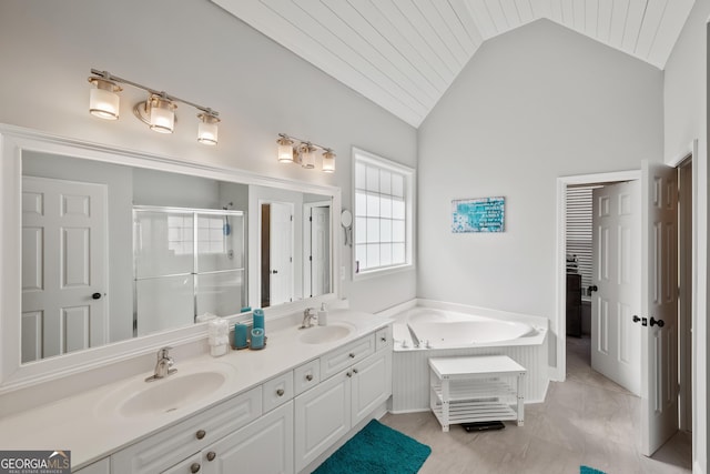 full bathroom featuring a sink, lofted ceiling, a stall shower, and double vanity