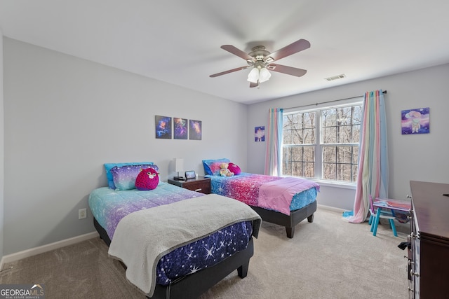 carpeted bedroom with visible vents, baseboards, and ceiling fan