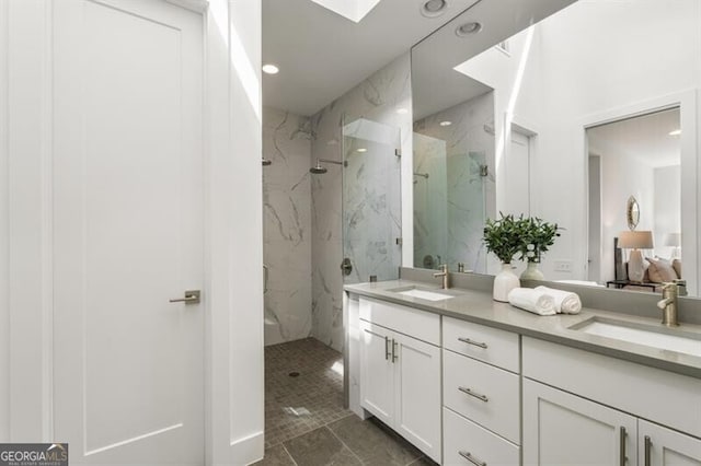 241 Maynard Ter SE Unit 17, Atlanta, GA 30316 - full bathroom featuring double vanity, a skylight, a sink, and a marble finish shower