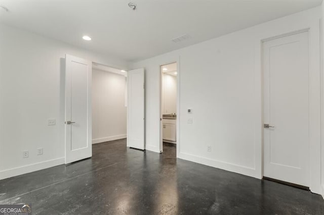 241 Maynard Ter SE Unit 17, Atlanta, GA 30316 - unfurnished bedroom featuring recessed lighting, visible vents, connected bathroom, concrete floors, and baseboards