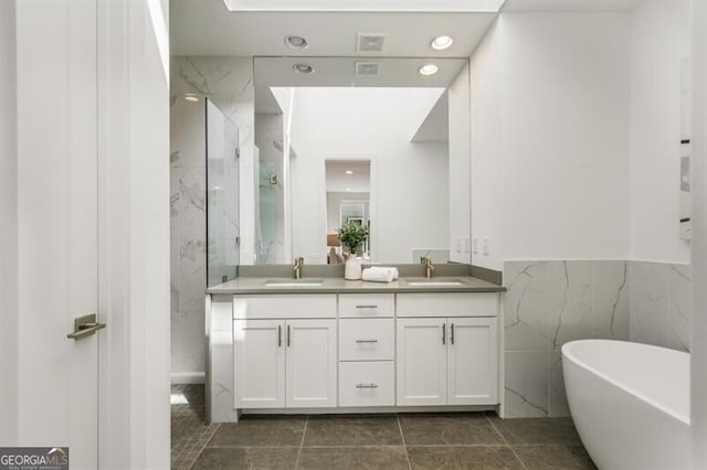 241 Maynard Ter SE Unit 17, Atlanta, GA 30316 - bathroom featuring double vanity, a freestanding bath, a marble finish shower, and a sink
