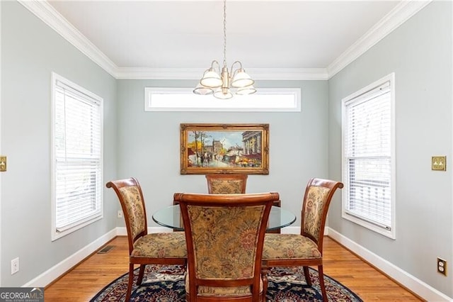 dining space featuring light wood finished floors, a chandelier, and a wealth of natural light