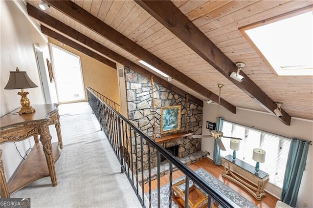 corridor featuring lofted ceiling with skylight, wooden ceiling, and wood finished floors