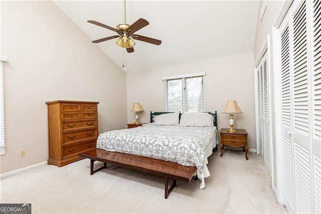 bedroom featuring baseboards, high vaulted ceiling, ceiling fan, and light colored carpet