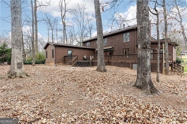 back of house with a deck