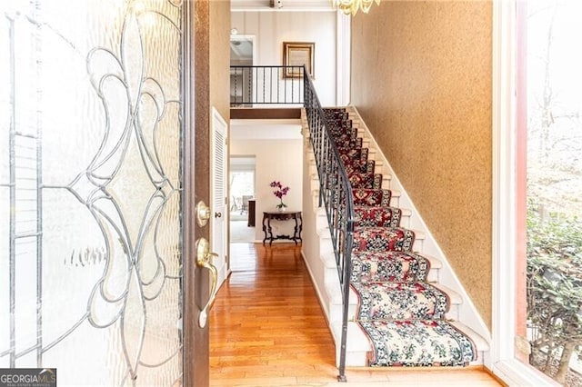 entrance foyer featuring stairs and wood finished floors