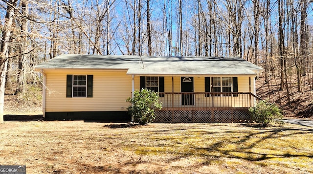 view of front of house with crawl space and a porch