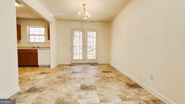 doorway with a notable chandelier, a sink, and baseboards