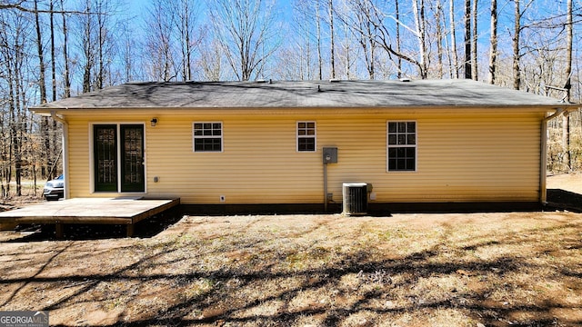 rear view of house featuring central AC