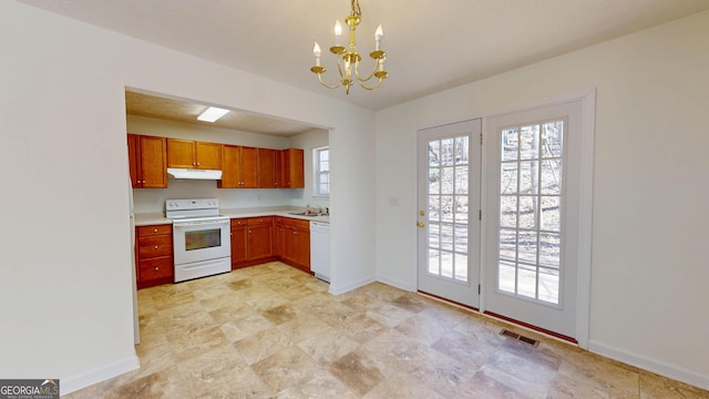 kitchen featuring white appliances, visible vents, light countertops, under cabinet range hood, and a chandelier