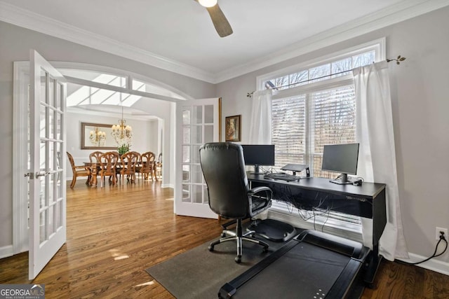 office area with french doors, ornamental molding, wood finished floors, baseboards, and ceiling fan with notable chandelier