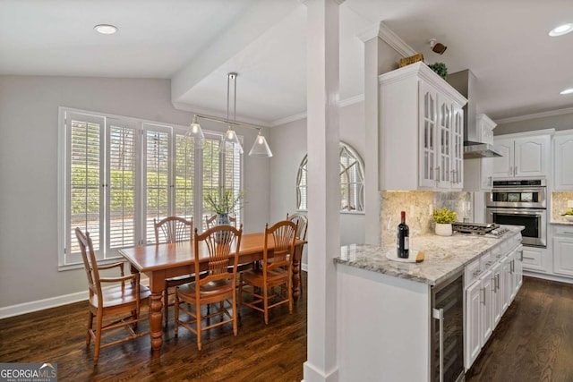 kitchen featuring wine cooler, stainless steel appliances, tasteful backsplash, dark wood-type flooring, and white cabinets