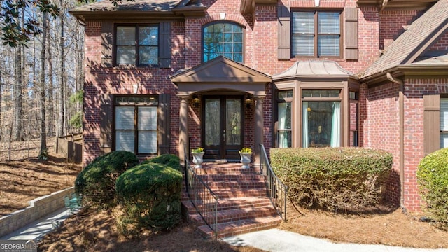 view of front of home with french doors and brick siding