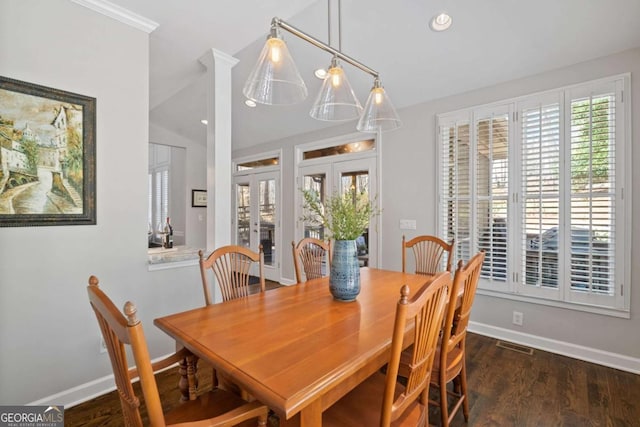 dining area with baseboards, a wealth of natural light, and wood finished floors