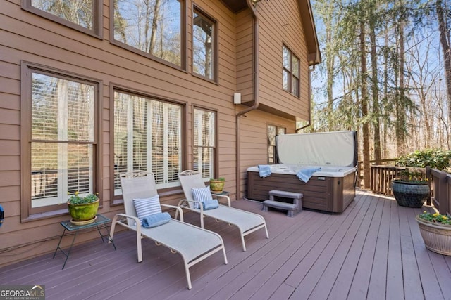 wooden terrace featuring a hot tub