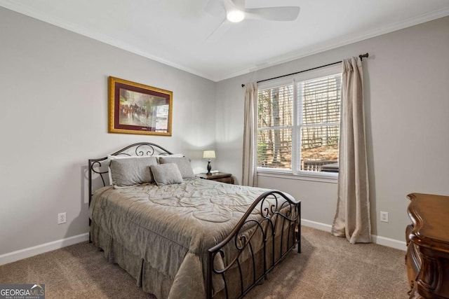 bedroom with carpet floors, ornamental molding, baseboards, and a ceiling fan