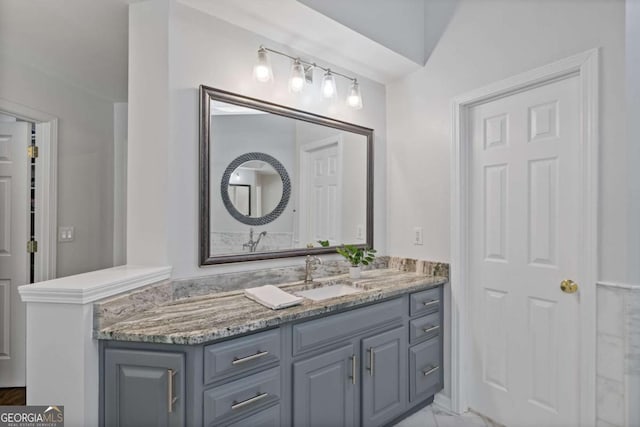 bathroom featuring marble finish floor and vanity