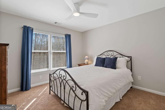 carpeted bedroom with visible vents, baseboards, and ceiling fan