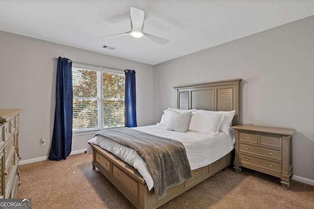 carpeted bedroom featuring baseboards, visible vents, and a ceiling fan