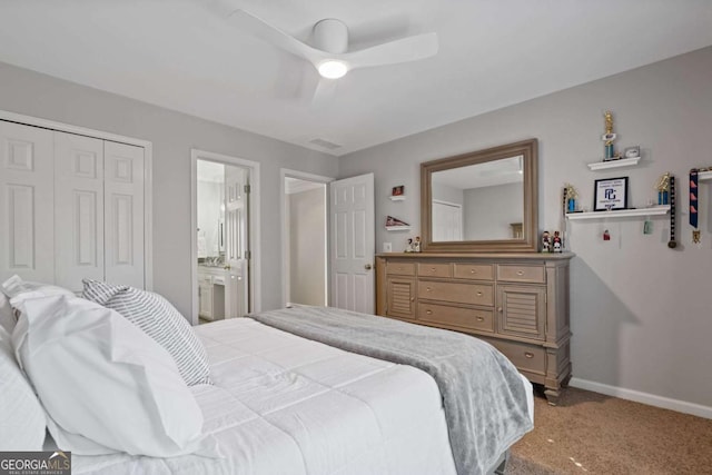 carpeted bedroom with baseboards, visible vents, ensuite bath, ceiling fan, and a closet