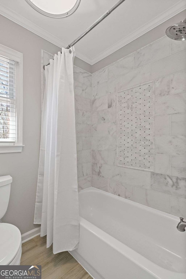 full bathroom featuring toilet, crown molding, baseboards, and wood finished floors