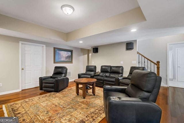 living area with dark wood finished floors, recessed lighting, visible vents, stairway, and baseboards