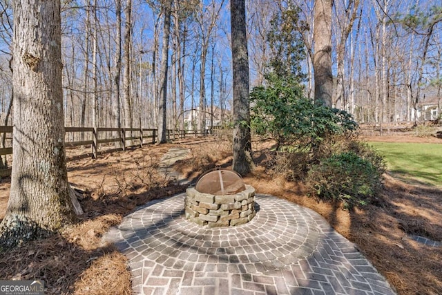 view of patio with a fire pit and fence