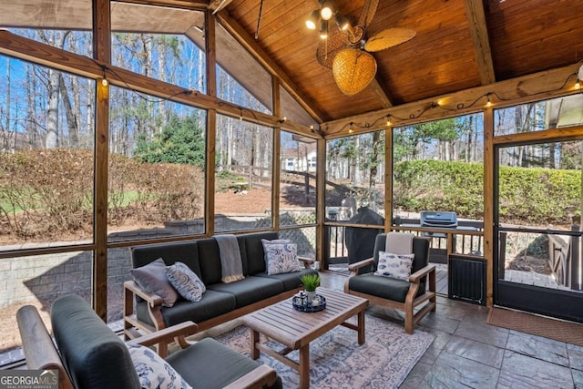 sunroom featuring a ceiling fan, wood ceiling, and lofted ceiling with beams