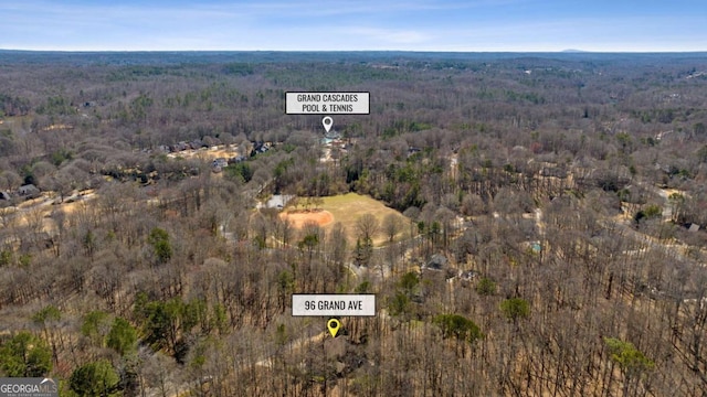 birds eye view of property featuring a view of trees