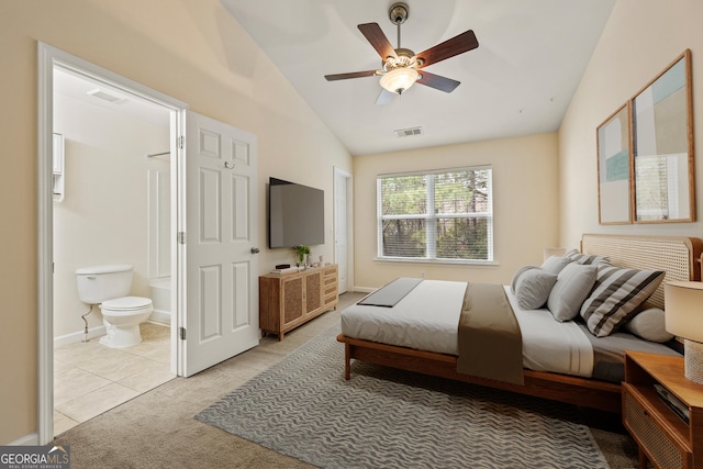 bedroom with lofted ceiling, ensuite bath, visible vents, and light colored carpet