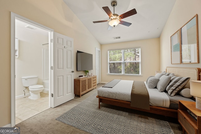 bedroom with lofted ceiling, light carpet, visible vents, and ensuite bathroom