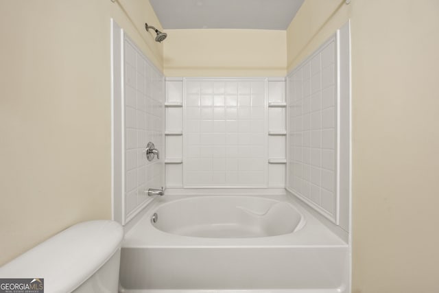 bathroom with bathtub / shower combination and toilet